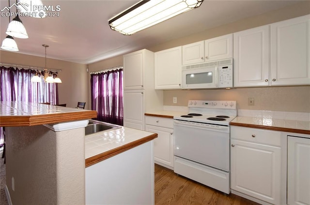 kitchen with white cabinets, tile counters, and white appliances