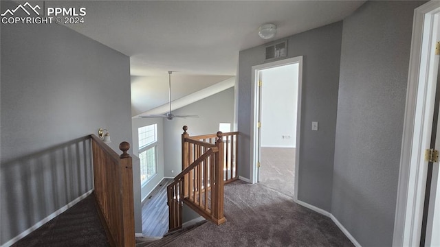 hallway with dark colored carpet