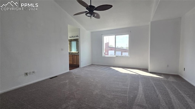 carpeted spare room featuring lofted ceiling and ceiling fan