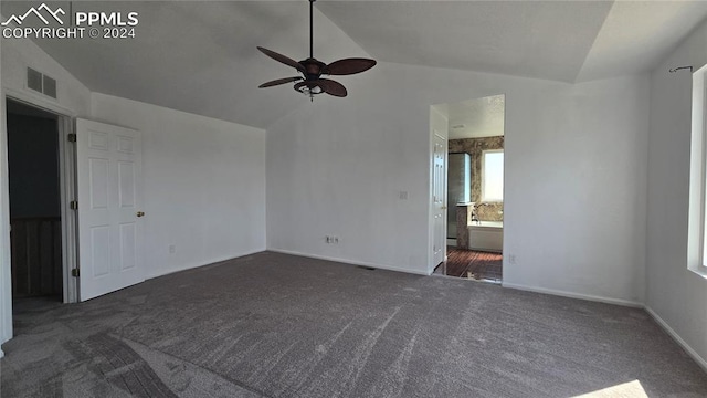 carpeted empty room with ceiling fan and vaulted ceiling