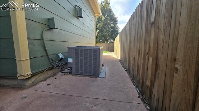 view of property exterior with a patio and central AC unit