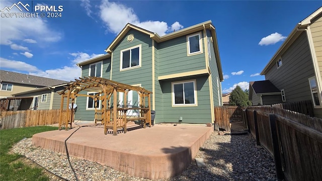 back of property featuring a pergola and a patio area