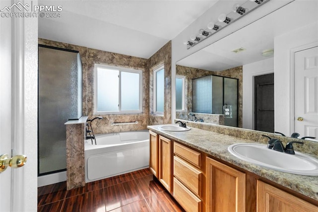 bathroom with vanity, tile patterned flooring, and plus walk in shower