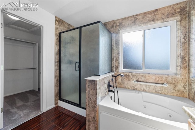 bathroom with vanity and shower with separate bathtub