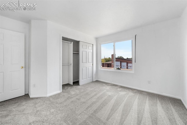 unfurnished bedroom featuring light colored carpet