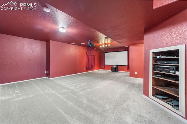 cinema with a textured ceiling and carpet flooring