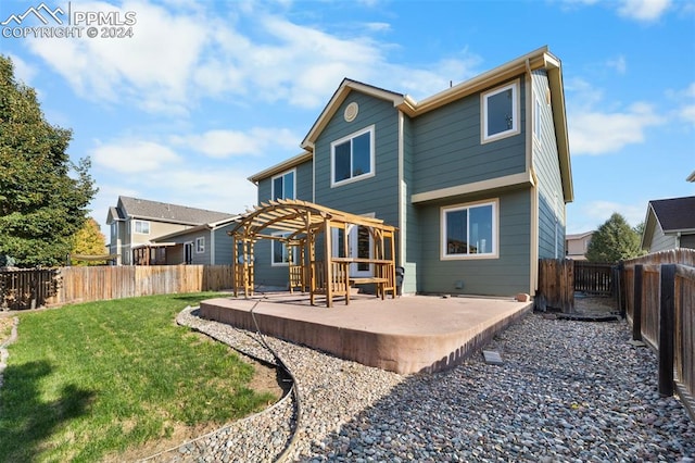 back of property featuring a yard, a patio, and a pergola