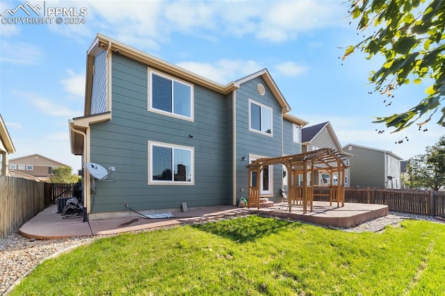 rear view of property featuring a pergola, a patio, and a yard