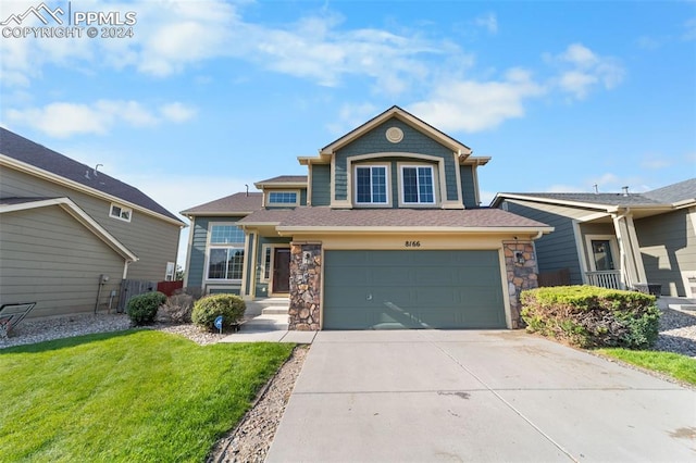 view of front of home with a front lawn and a garage