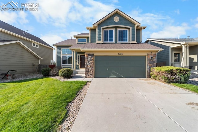 view of front of property with a front lawn and a garage