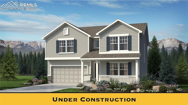 view of front of home with a mountain view and a garage