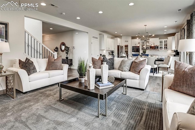 living room featuring hardwood / wood-style flooring and a chandelier