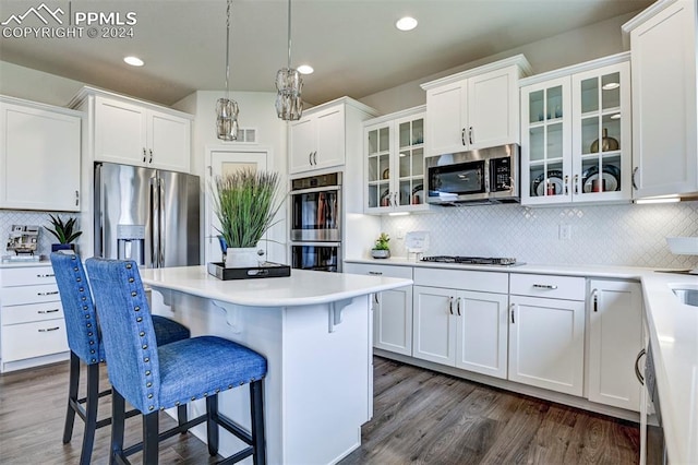 kitchen with stainless steel appliances, tasteful backsplash, dark hardwood / wood-style flooring, and white cabinets