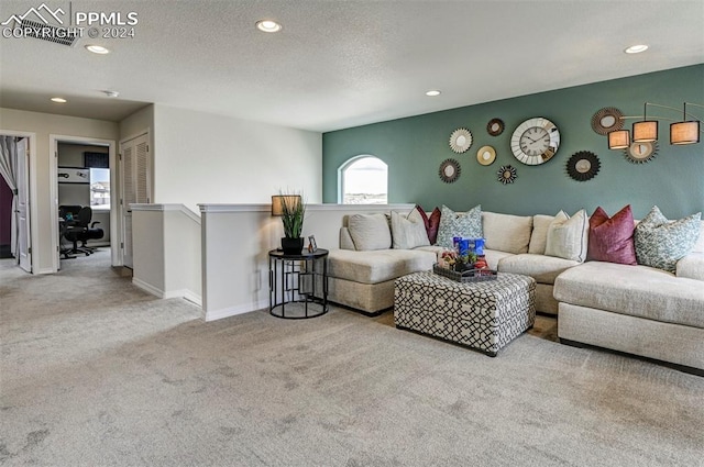 carpeted living room with a textured ceiling