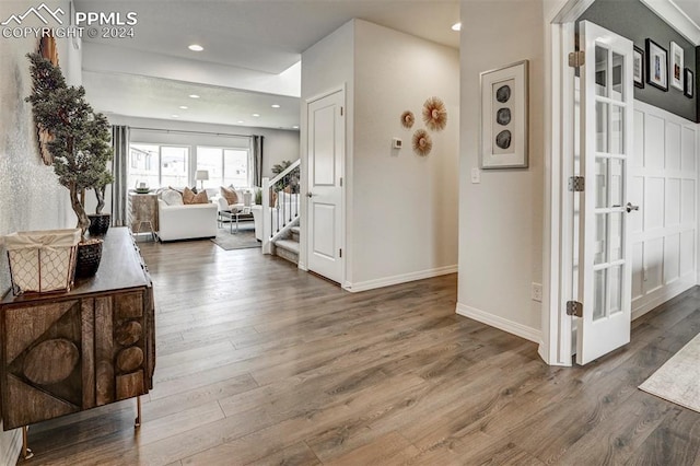 hallway with hardwood / wood-style flooring