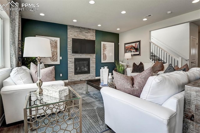 living room with a fireplace and wood-type flooring