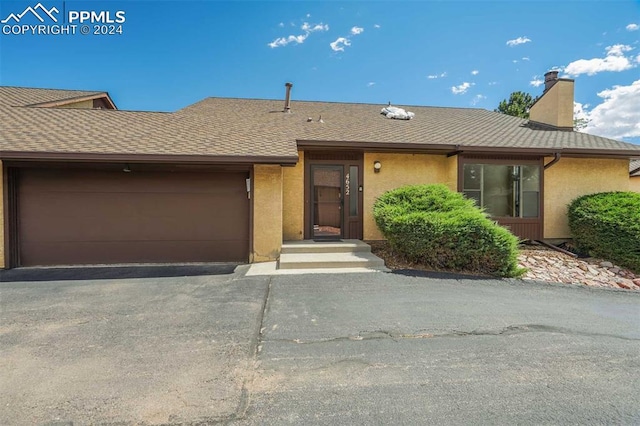 single story home with a garage