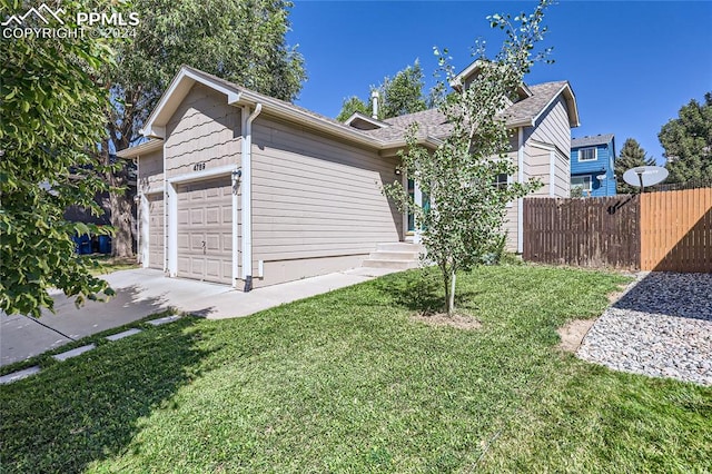 view of home's exterior featuring a lawn and a garage