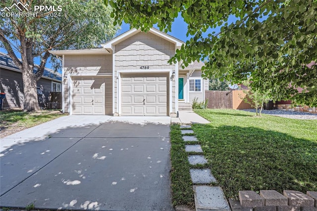 view of front of property with a garage and a front lawn