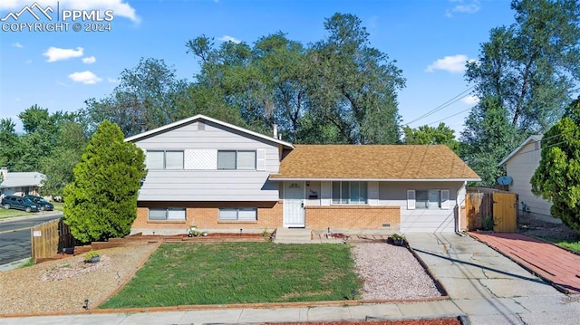 tri-level home with a front yard