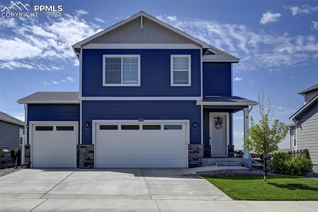 view of front of home with driveway, a garage, stone siding, an attached garage, and a front lawn