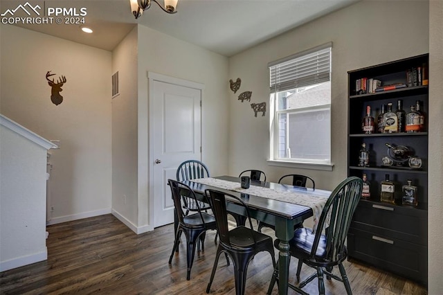 dining room featuring wood finished floors, visible vents, and baseboards