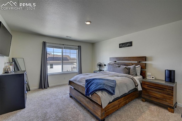 carpeted bedroom featuring a textured ceiling