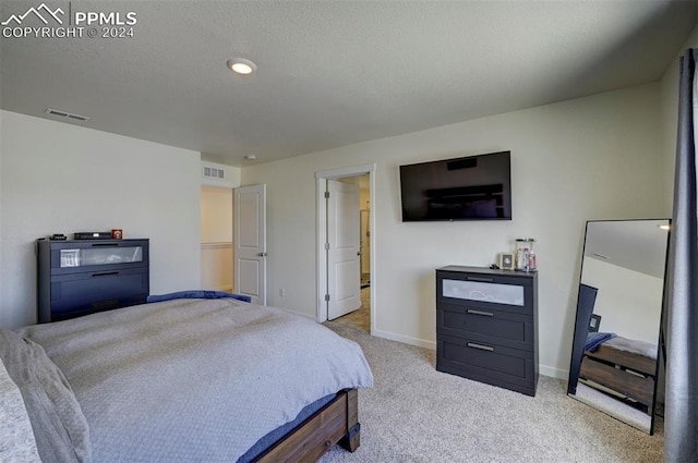 carpeted bedroom featuring visible vents and baseboards