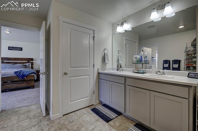 bathroom featuring tile patterned floors and dual bowl vanity