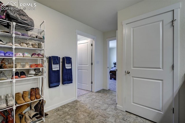 walk in closet with light tile patterned flooring