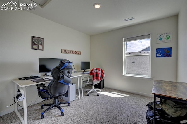 carpeted home office featuring visible vents and baseboards