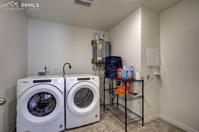 clothes washing area featuring washer and dryer and water heater