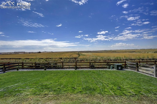 view of dock with a rural view and a yard