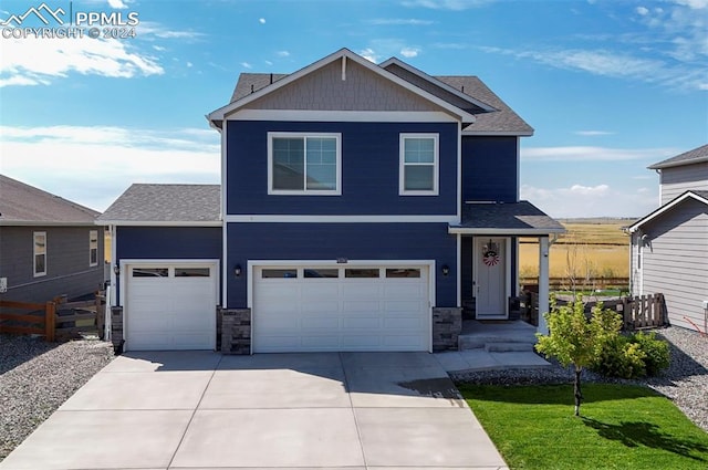 view of front of home with concrete driveway, stone siding, an attached garage, and fence