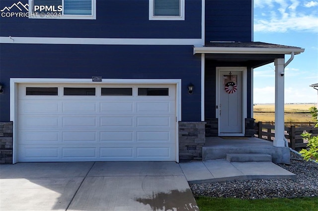 doorway to property with a garage