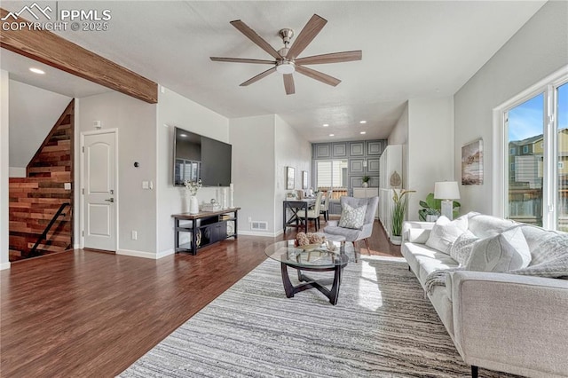 living room featuring stairway, wood finished floors, visible vents, and a healthy amount of sunlight