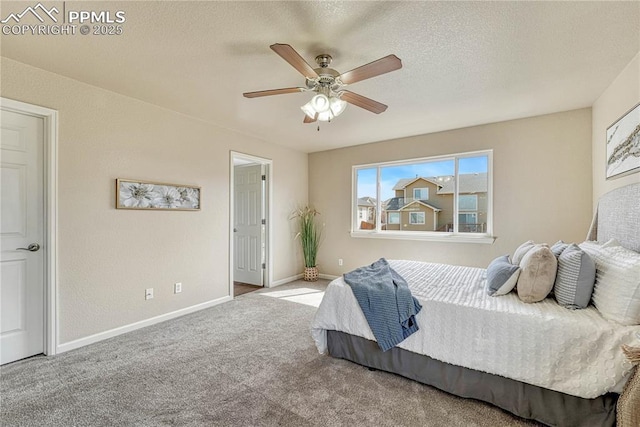 bedroom featuring baseboards, carpet floors, a textured ceiling, and ceiling fan