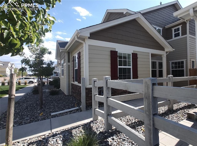 view of side of property featuring fence