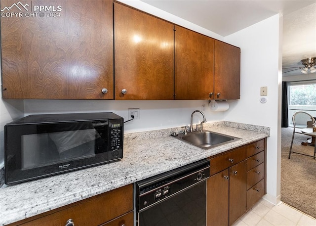 kitchen with sink, light stone countertops, light carpet, ceiling fan, and black appliances