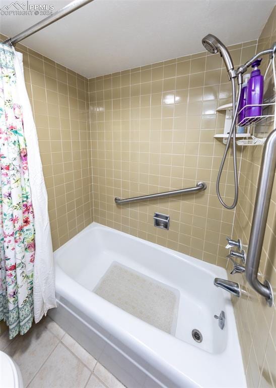 bathroom with tile patterned floors and shower / bath combination with curtain