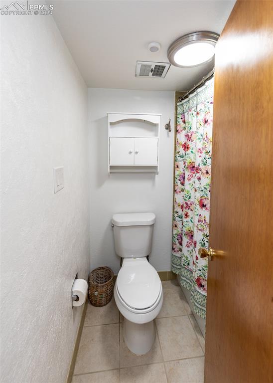 bathroom with tile patterned floors and toilet