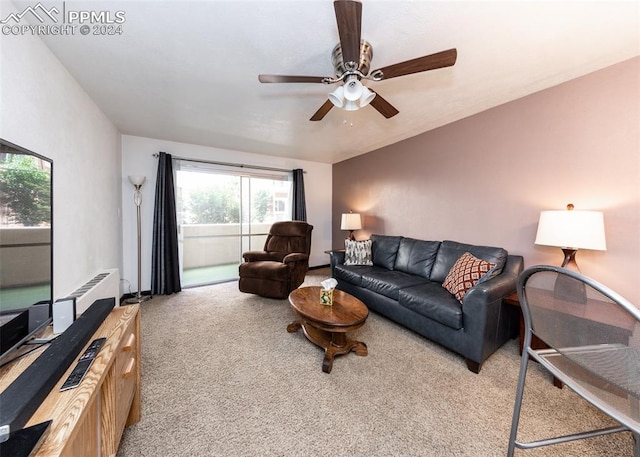 living room with ceiling fan and carpet