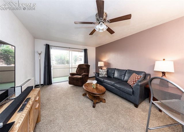living room featuring carpet and a ceiling fan