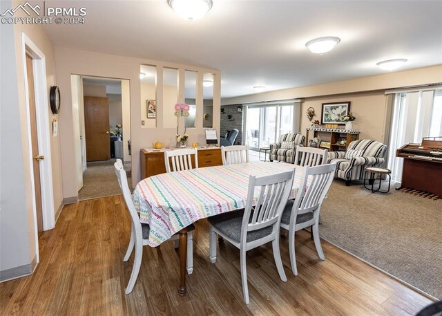 dining space with wood-type flooring