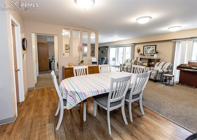 dining room featuring baseboards and light wood-type flooring