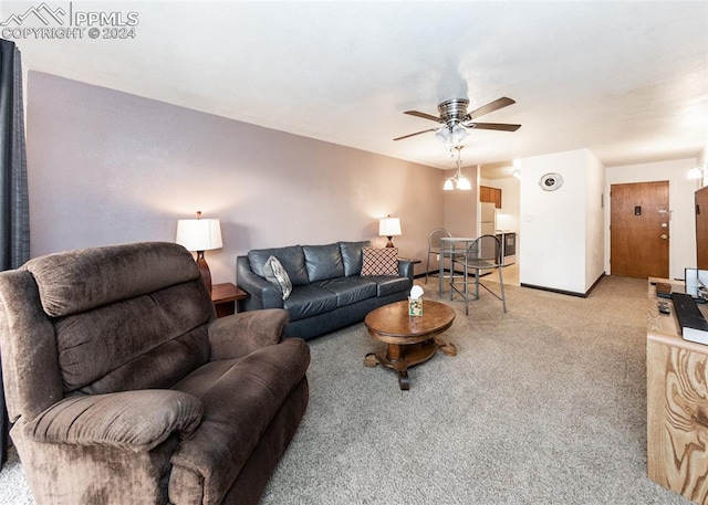 living room featuring carpet, a ceiling fan, and baseboards