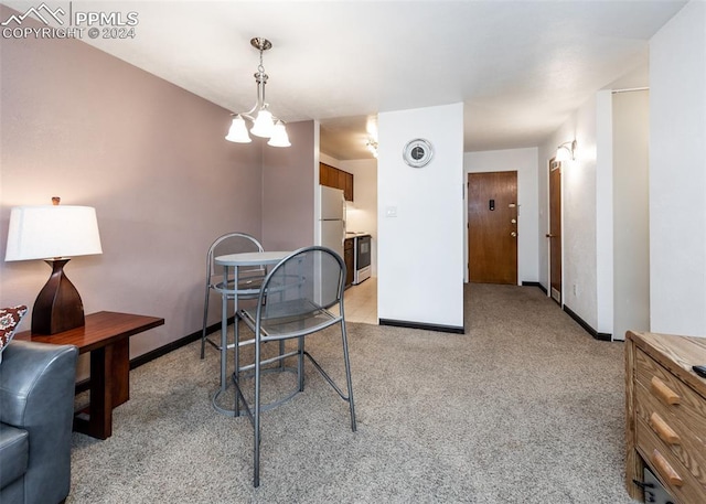 dining space with light carpet, visible vents, a chandelier, and baseboards