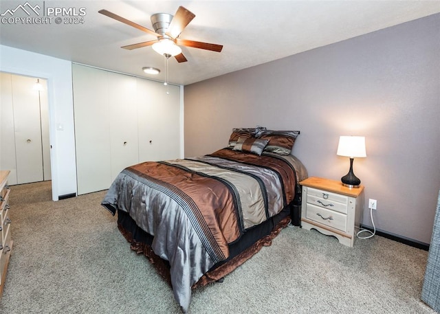 bedroom with light carpet, ceiling fan, and a closet