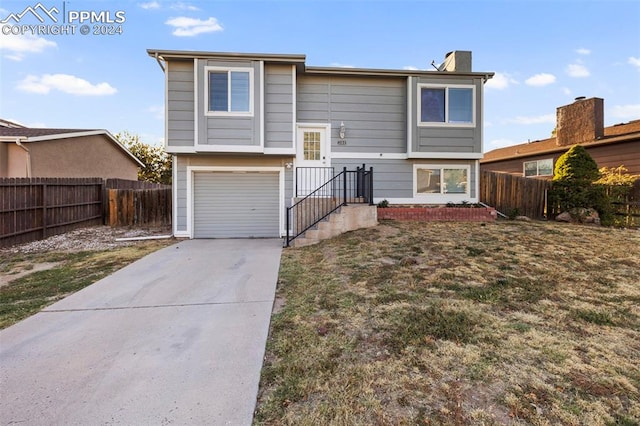 view of front of property with a front lawn and a garage