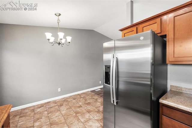 kitchen featuring lofted ceiling, a chandelier, stainless steel refrigerator with ice dispenser, and hanging light fixtures